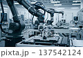 Automated robotic arms in a high-tech factory laboratory assembling complex electronic components on a conveyor belt with sparks flying, blurred industrial interior background. 137542124