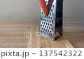 food grater scraping shredding and grinding when grating a carrot 137542322