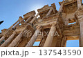 Low angle view of the Library of Celsus in Ephesus, Turkey. Famous ancient Roman landmark with detailed marble columns and facade, one of the most important archaeological sites in the Mediterranean. 137543590
