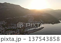 Aerial sunrise view over Kas town and marina on the Mediterranean coast of Turkey. Warm golden light over mountains, harbor and coastal town creating a peaceful scenic landscape. 137543858