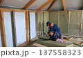 Insulation of a frame house with mineral wool. Cutting, fitting, laying insulation. Construction works. 137558323