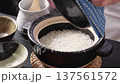 Chef opening the lid of a rice cooker 137561572