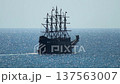 Big dark ancient sailing masthead ship legend traverses sparkling blue sea water. Largest pirate-themed tour vessel with multiple masts furled sails travels in Alanya Turkey 137563007
