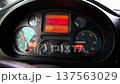 Instrument cluster of vehicle dashboard, displaying speedometer, tachometer, fuel gauge, temperature gauge, warning lights and digital information screen 137563029