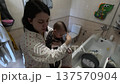 Mother and Child Brushing Teeth Together 137570904