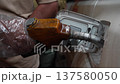 Closeup Of Petrol Pump And Nozzle. Attendant Carefully Refilling Vehicle Using Safety Procedures. Iran 137580050
