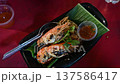 Grilled prawns with dipping sauce on garnished plate, close-up shot 137586417
