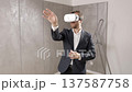 Young man wearing VR glasses, scrolling with hands in air using futuristic innovative technology choosing home design. Repair and renovation concept. Virtual reality 137587758