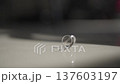 Wedding rings spinning on table in slow motion. 137603197