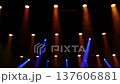 Moving concert spotlights create dynamic warm lighting effects on stage in slow motion, professional event light show equipment, performance, stage background, event production 137606881