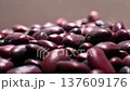 A close-up of a large amount of red kidney beans in a clear storage jar. Macro shot of the beans with a shallow depth of field. 137609176