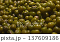 Close-up of mung beans. Lots of small green beans in a clear storage jar. Raw beans. Healthy and wholesome food. 137609186