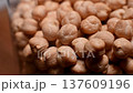 Close-up sequence of dried chickpeas in a glass container, showcasing their texture and color variations, with a blurred background emphasizing the focus on the legumes 137609196