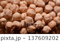 Close-up macro of raw chickpea kernels in a clear storage jar 137609202