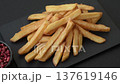 French fries, a salty, crispy, homemade snack with spices. French fries on a black background 137619146
