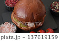 A burger with a patty, cheese, vegetables, and sauce. A burger with meat 137619159