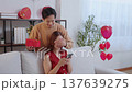 Romantic asian man covering girlfriend eye to surprise with heart gift box for celebrating. 137639275