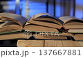 Stack of open books forming layered pages in quiet reading environment 137667881