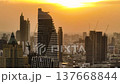 Silhouette of modern skyscrapers and urban skyline during a vibrant sunset over the city. Bangkok, Thailand. 137668844