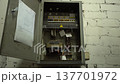 Electrical control panel open in a basement showing wires and connections during a routine inspection in a home 137701972