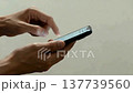 Japanese person's hands operating a smartphone (App introduction/Copy space) 137739560