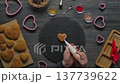 Woman decorating heart shaped gingerbread cookies for Valentine Day top view 137739622