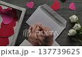 Man Hand Putting Handmade Valentine Card into Envelope Top View DIY Craft 137739625