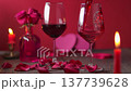 red wine pouring into a stemware glass on a rustic wooden table 137739628