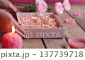 Women Hands Putting Colorful Iced Gingerbread Hearts in Gift Box Close Up 137739718