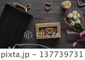 Women Hands Putting Iced Gingerbread Hearts in Kraft Gift Box Top View 137739731