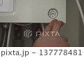 Man pointing to barometer on the panel of the gas boiler and making higher water pressure. 4K 137778481