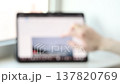 Blurred Video of Person Scrolling Through Website on Tablet Screen. Light office scene. Sunny day 137820769