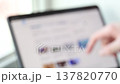 Blurred Video of Person Scrolling Through Website on Tablet Screen. Light office scene. Sunny day 137820770