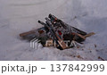Smoking Campfire in Snow Pit After Burning 137842999