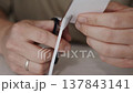 Scissors Cutting Narrow Strip from White Paper 137843141