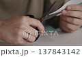Scissors Opening in Hands After Cutting Paper 137843142