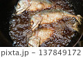 4K Closeup of deep frying short mackerel in a pan with bubbling hot oil 137849172