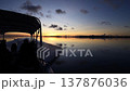A scene from Palau: a calm, mirror-like sea surface and a dawn sky. A scene from Palau: a calm, mirror-like sea surface and a dawn sky. 137876036