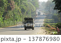 Vehicles driving along a road in rural Myanmar 137876980