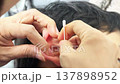 INCHEON, SOUTH KOREA - MARCH 17, 2026: Close-up of a Mother's Hand Carefully Cleaning Her Child's Ear with a Cotton Swab 137898952