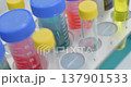 Group of transparent test tubes in a rotary laboratory shaker, close-up real time handheld shot, selective focus 137901533