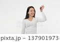 Young adult woman holds the keys to buying a car or apartment white background isolated space happy 137901973