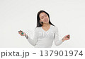 Young adult woman smoking an electronic cigarette white background isolated space 137901974