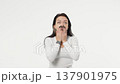 Young adult woman looks shock curiously fearfully white background isolated space 137901975