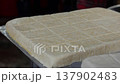 Piece of sliced tofu placed on a tray at a market stall where soybean products are sold as simple 137902483