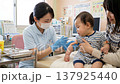 A scene of a baby receiving vaccinations at a medical institution in Japan. 137925440