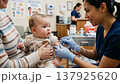 A scene of a baby receiving vaccinations at a medical facility. 137925620