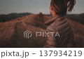 A woman enjoying her adventure in the Carpathian Mountains during dusk, capturing the beauty of the landscape and her joy in exploration. 137934219