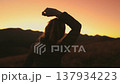 Woman dancing in sunset mountains close up. Caucasian girl listening music, having fun and relax against bright color sky in autumn alpine countryside. Outdoor lifestyle travel vacation. Slow motion 137934223