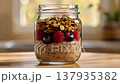 Delicious Breakfast Jar with Berries and Granola on a Wooden Table 137935382